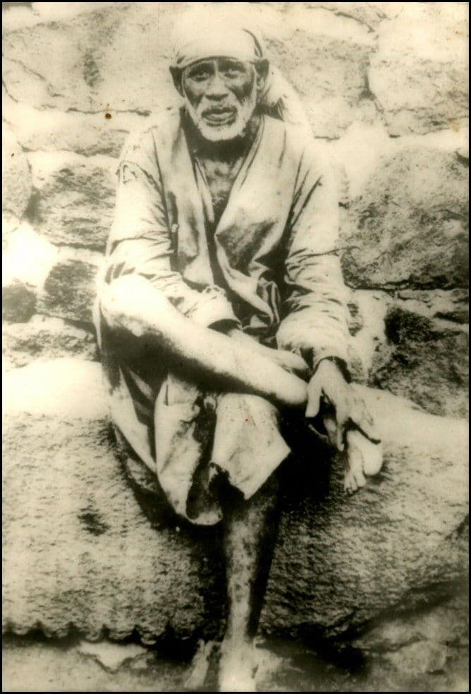 Shirdi Sai Baba seated on stone